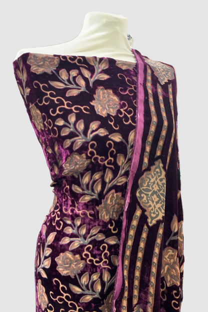 Mannequin wearing a purple printed garment in a store setting