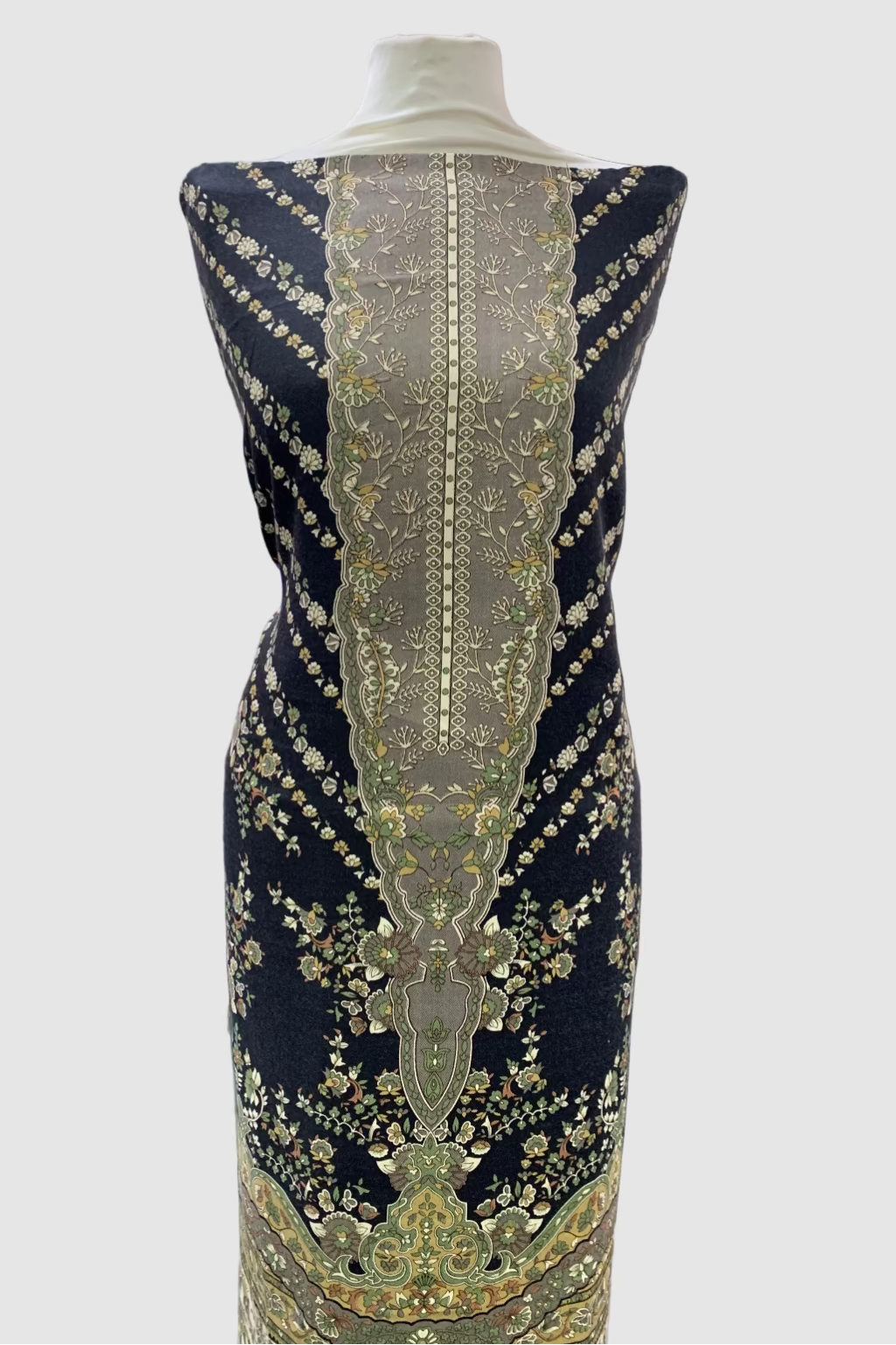 Mannequin wearing a black dress with gold floral print in a fabric store.