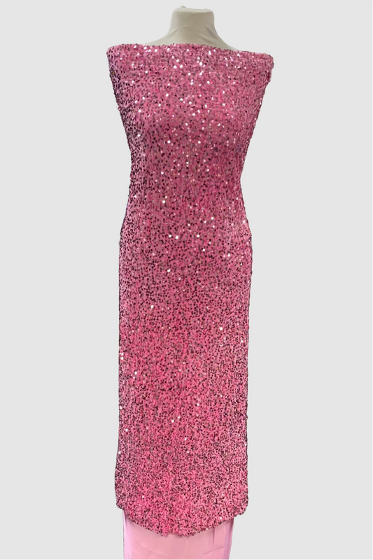 Pink sequin dress on a mannequin in a fabric store