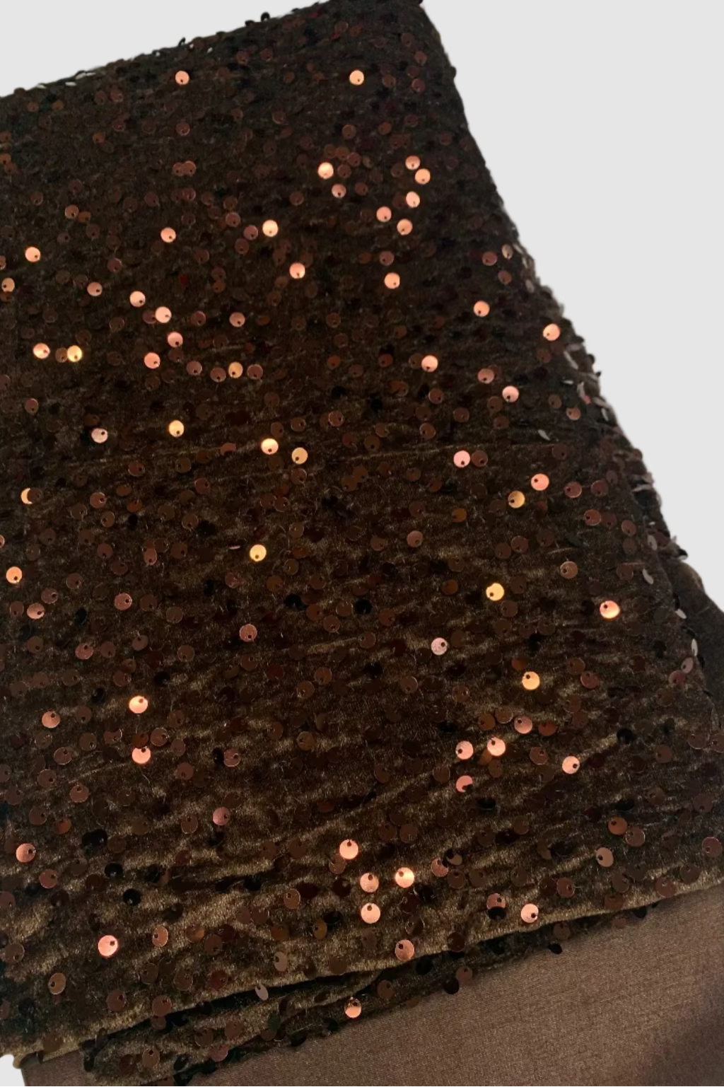 Brown fabric with sequins on a white background