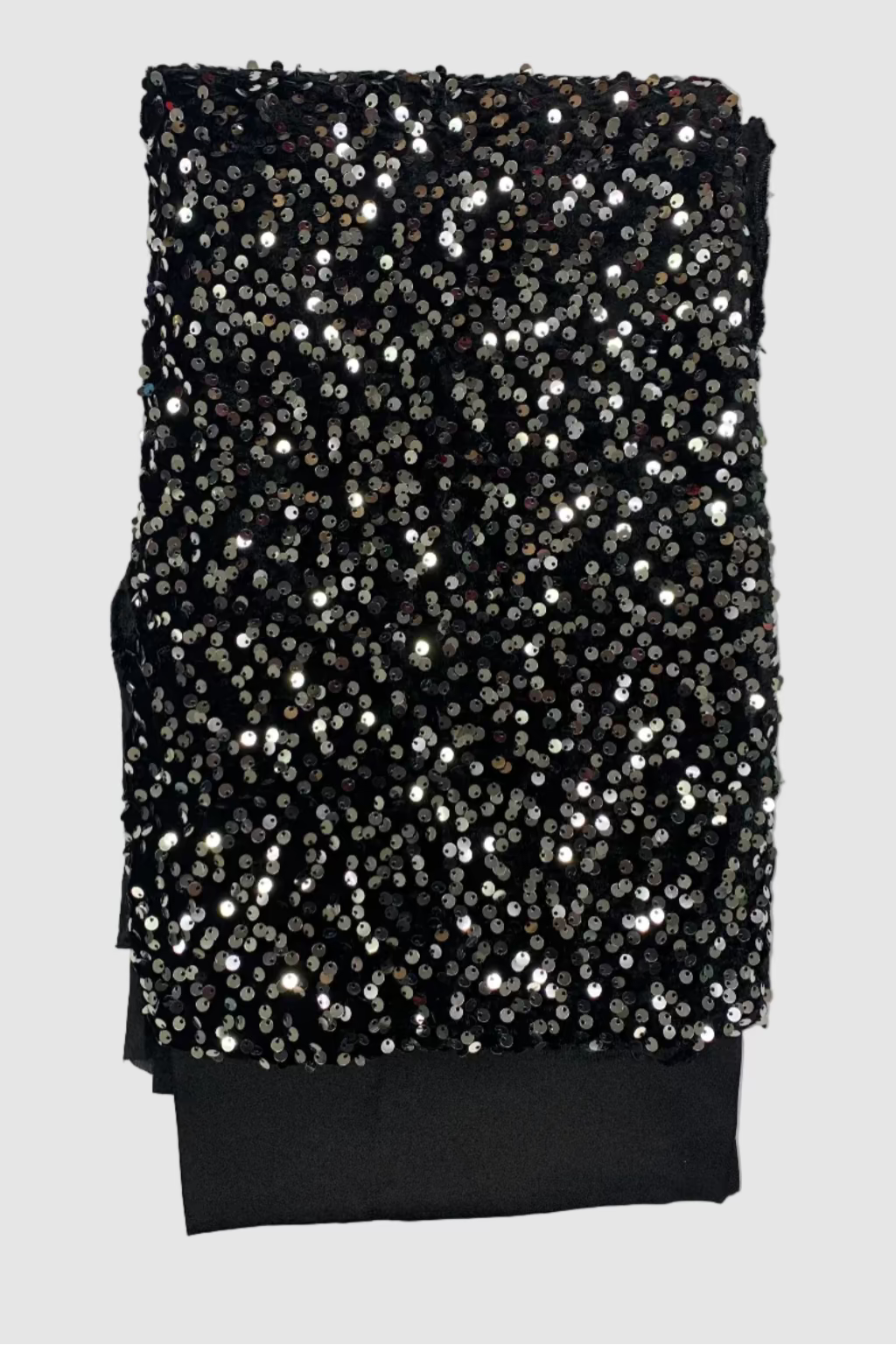 Black velvet fabric with silver sequins on a white background