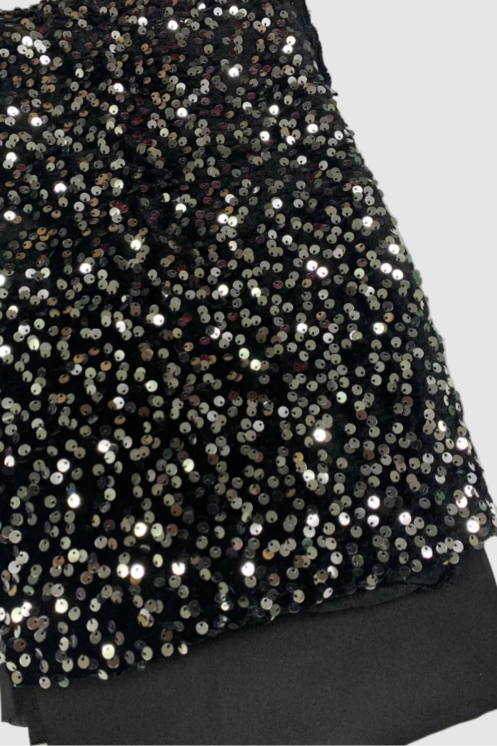 Black sequin fabric on a white background