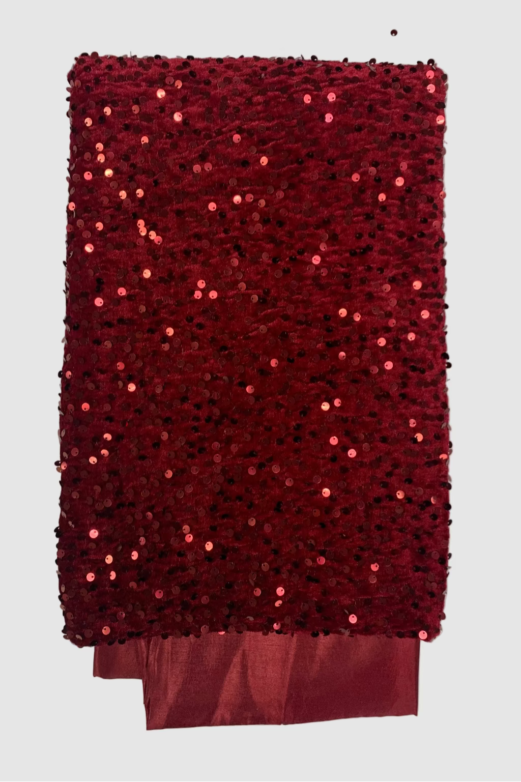 Red sequined fabric on a white background