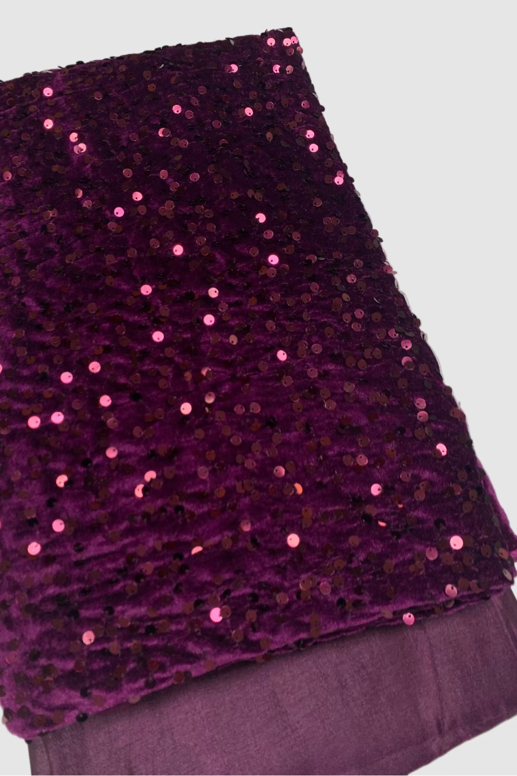 Purple fabric with sequins on a white background