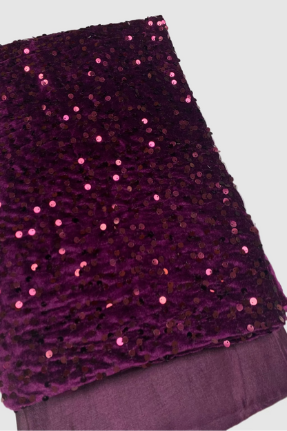Purple fabric with sequins on a white background