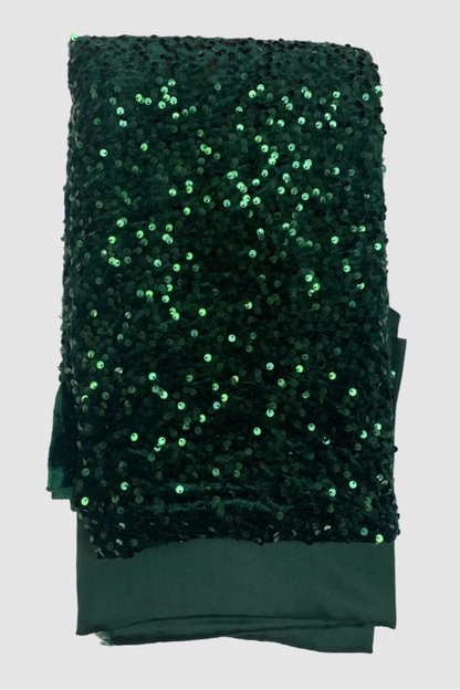 Green sequined fabric on a white background