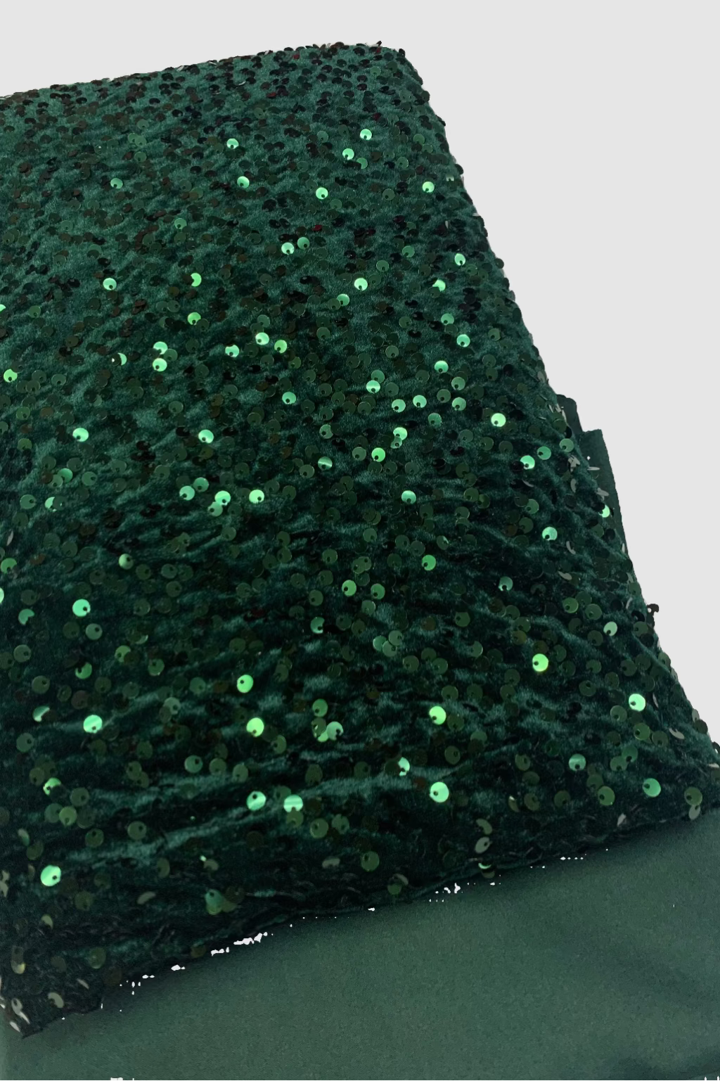 Green sequin fabric on a flat surface