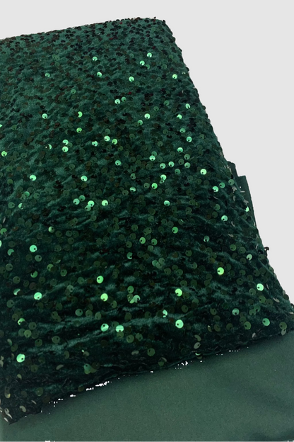 Green sequin fabric on a flat surface