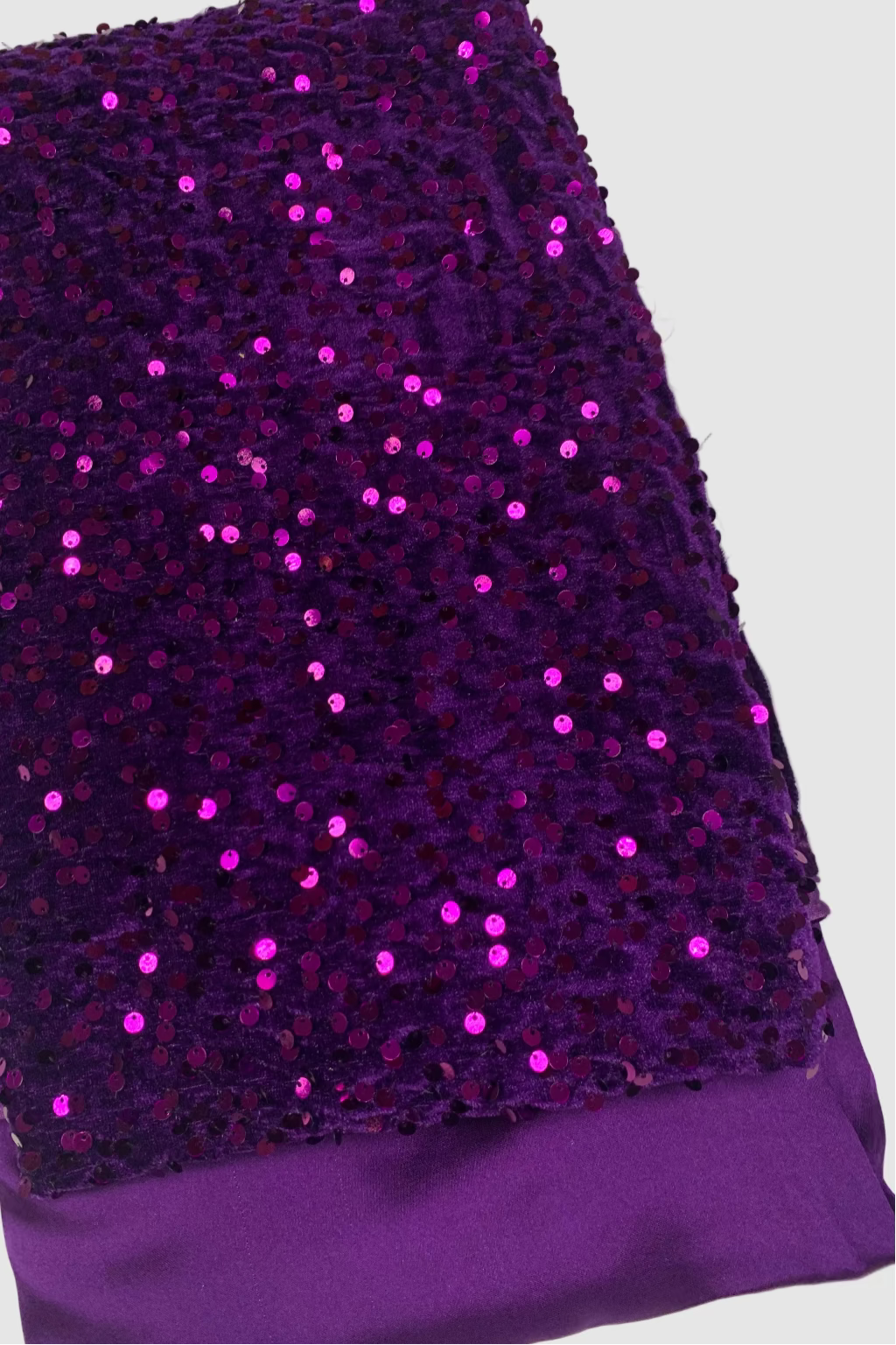 Purple fabric with sequins on a white background