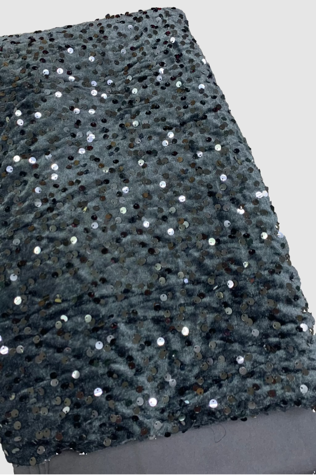 Grey sequin velvet fabric on a white background
