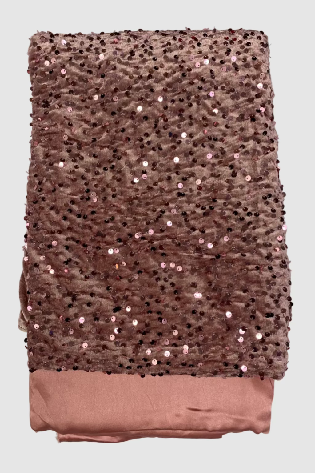 Peach velvet fabric with sequins on a white background