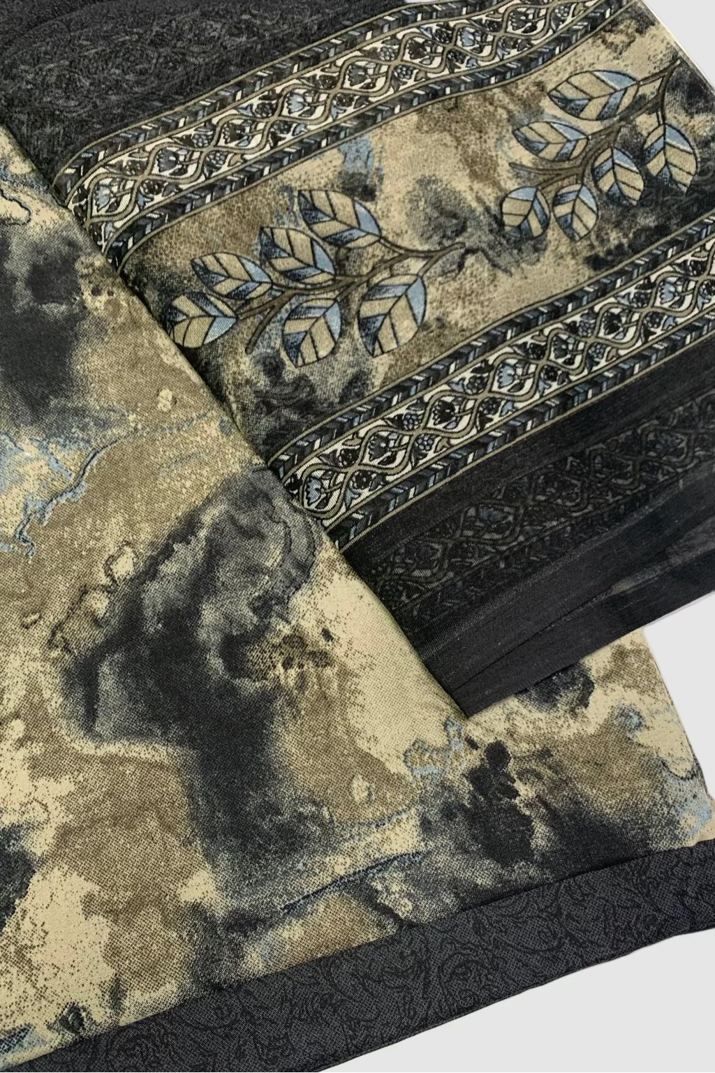 Floral fabric with intricate patterns and black borders on a white background