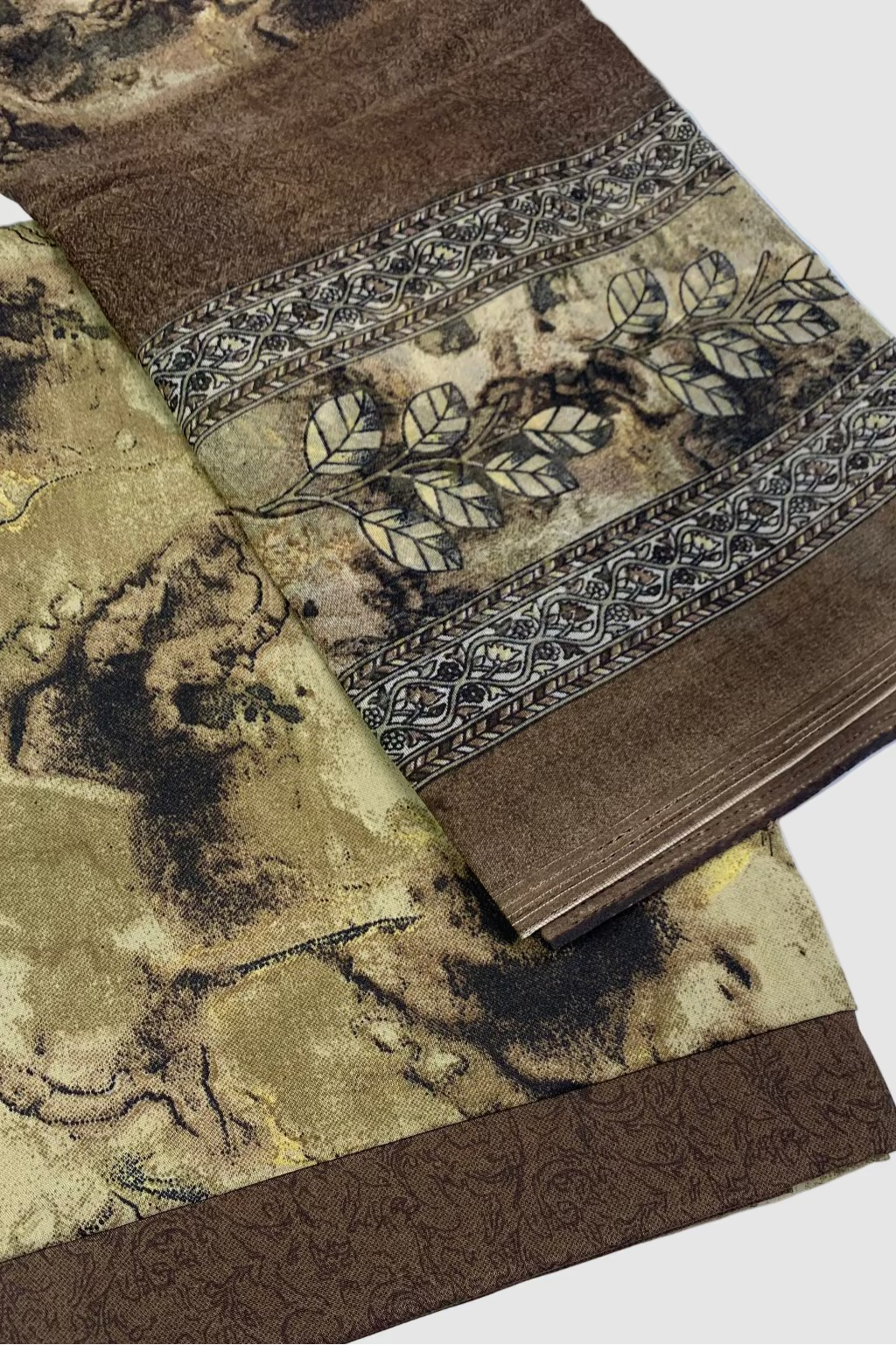 Floral print fabric with brown and beige patterns on a white background