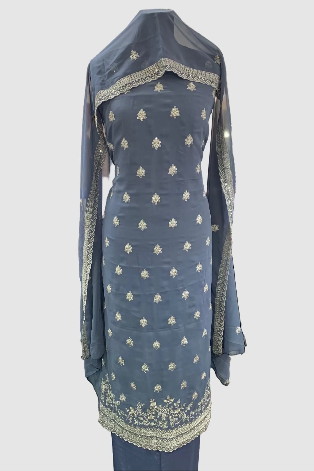 Grey embroidered dress with matching dupatta on a mannequin in a store setting.