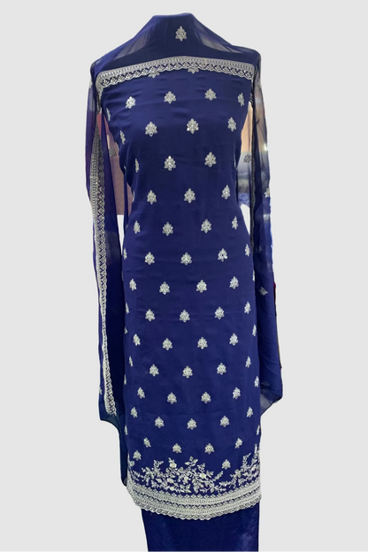 Blue embroidered dress on a mannequin in a store setting