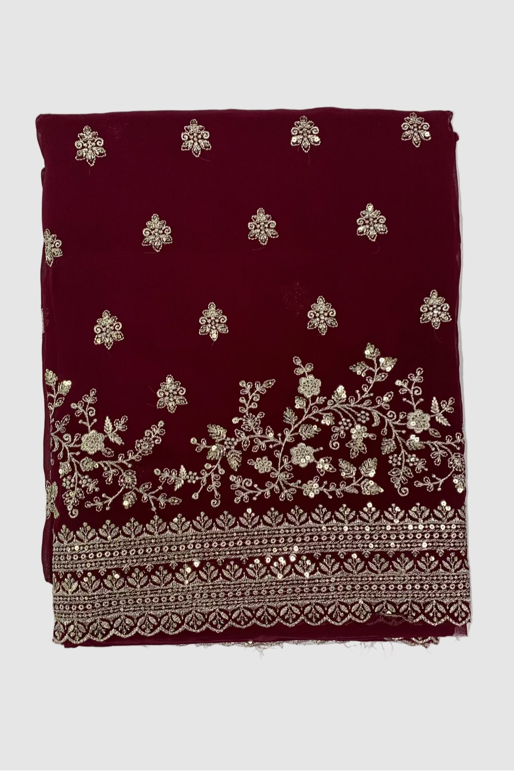 Maroon fabric with silver floral embroidery on a white background