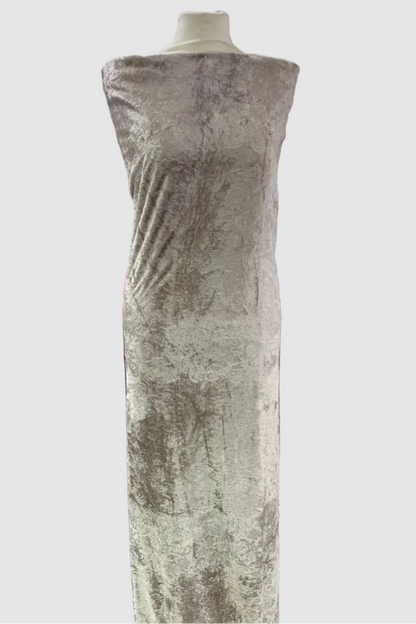 Taupe crushed velvet dress on a mannequin in a fabric store.