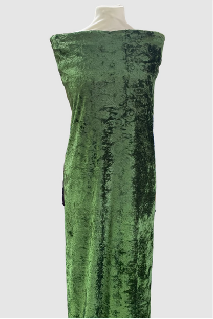 Green velvet fabric on a mannequin in a fabric store