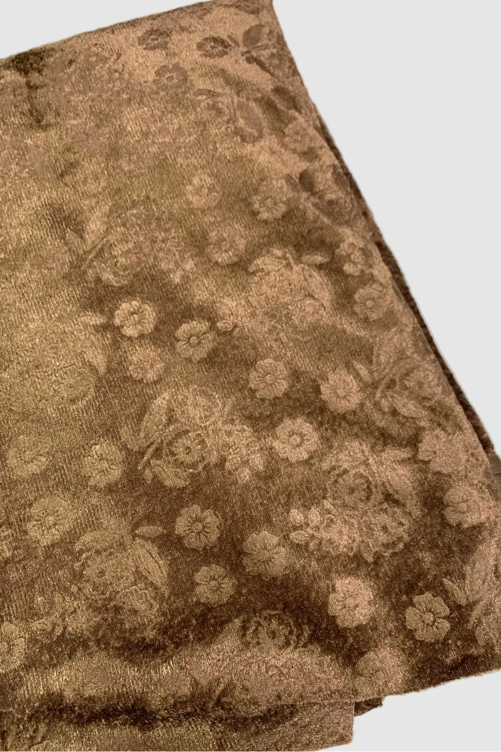 Brown fabric with floral pattern on a white background