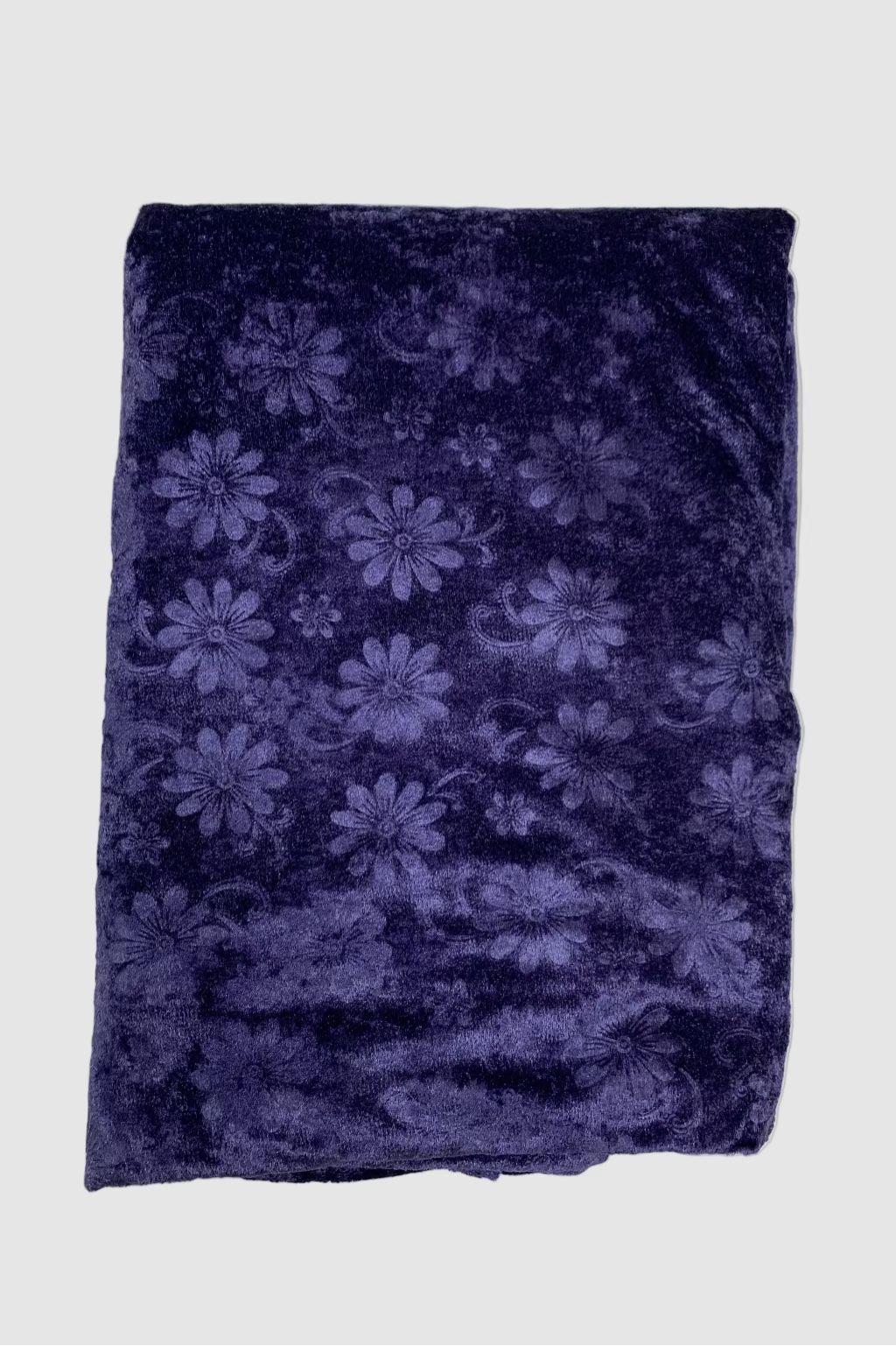 Folded blue fabric with floral pattern on a white background