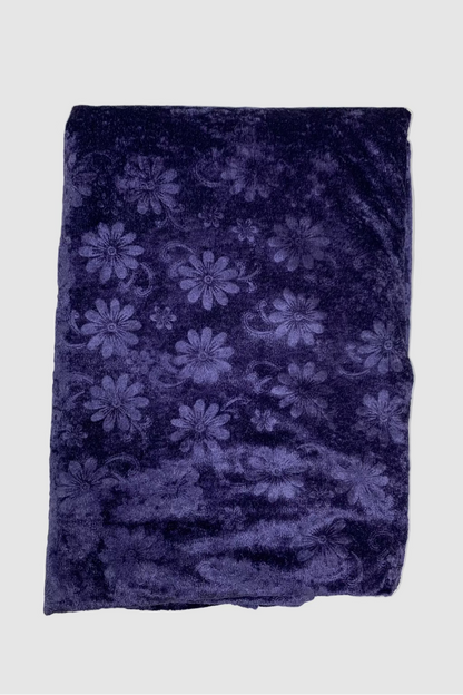 Folded blue fabric with floral pattern on a white background