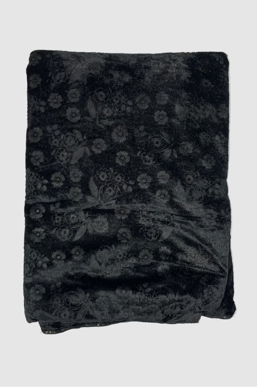 Black floral patterned fabric on a light beige background