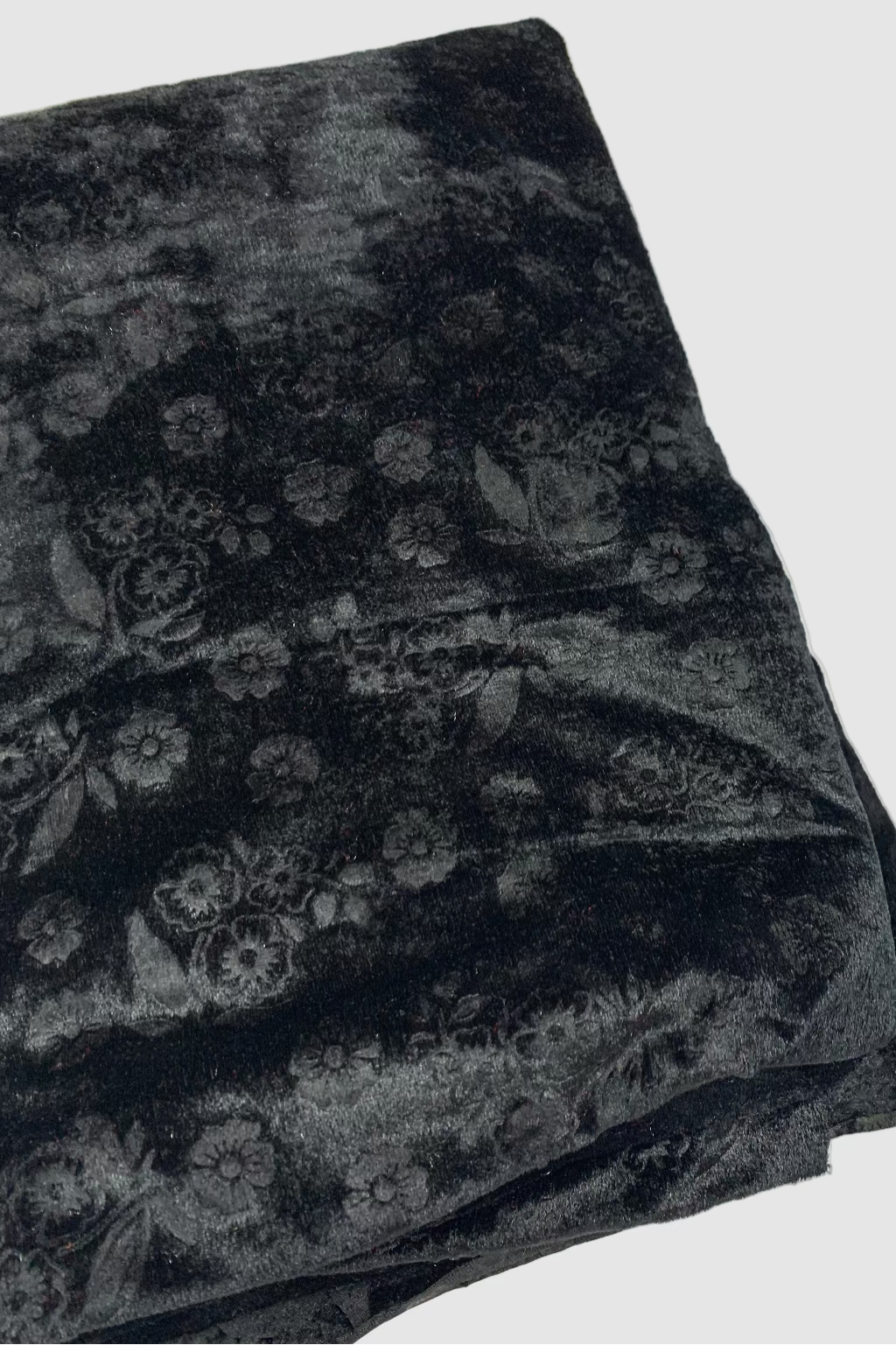 Black fabric with floral patterns on a white background