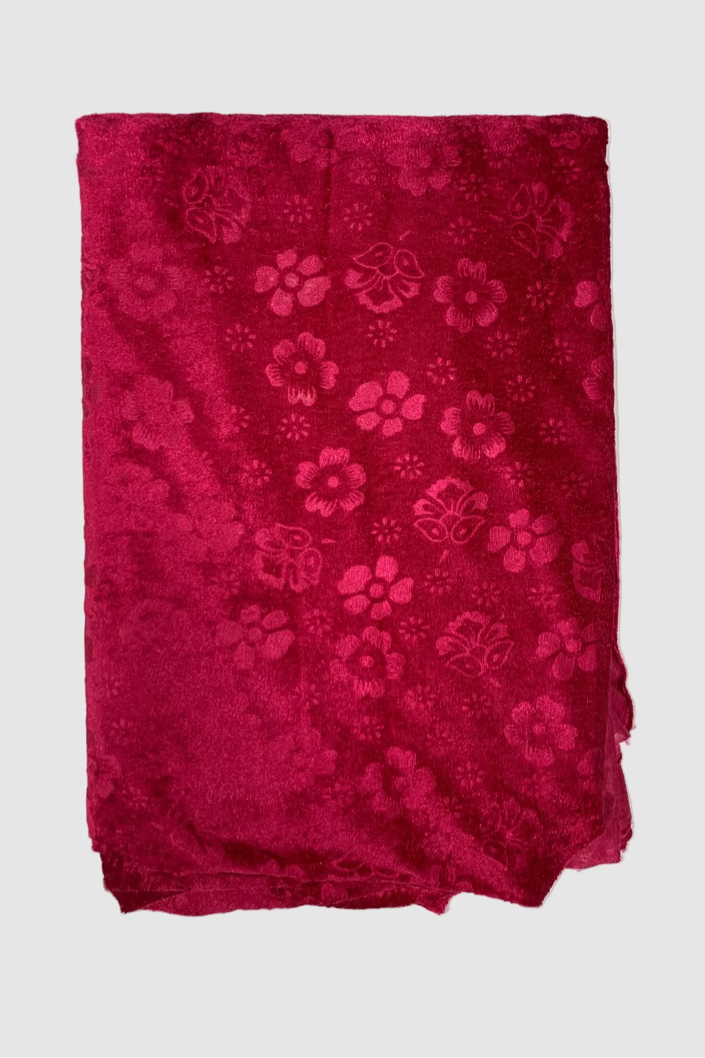 Pink fabric with floral patterns on a light white background