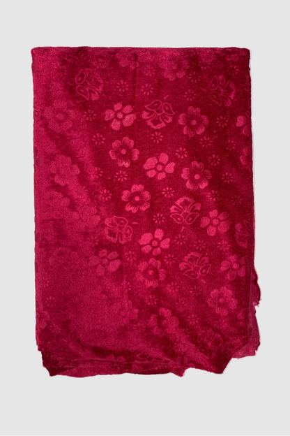 Pink fabric with floral patterns on a light white background