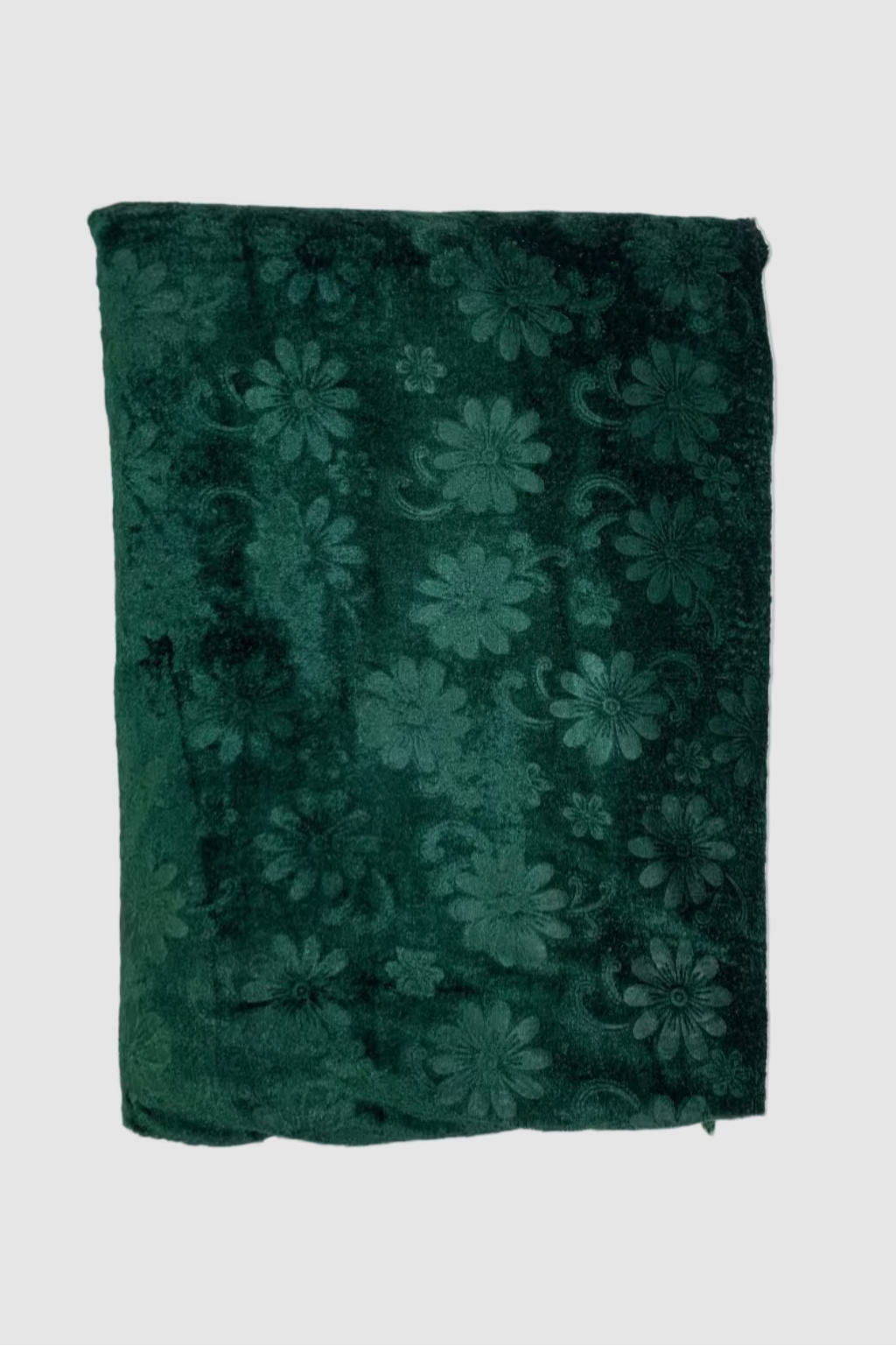 Folded green fabric with floral pattern on a white background