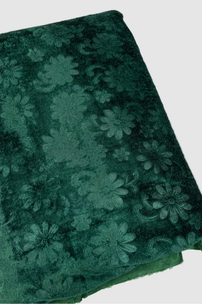 Green floral patterned fabric on a white background