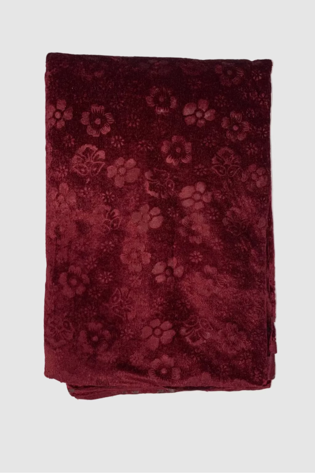 Folded maroon fabric with floral pattern on a white background