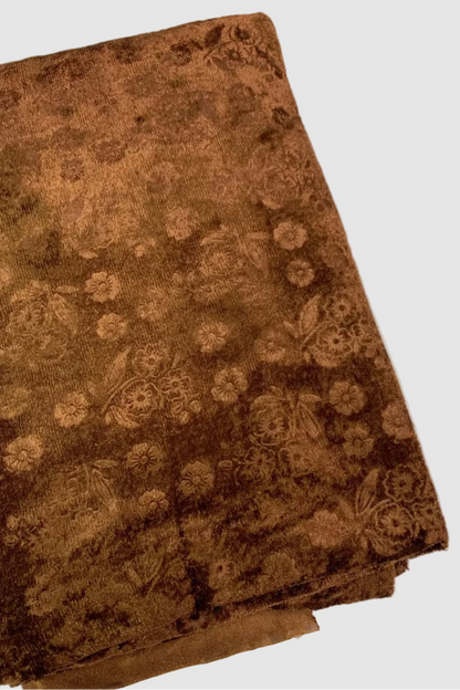 Brown floral-patterned fabric on a white background