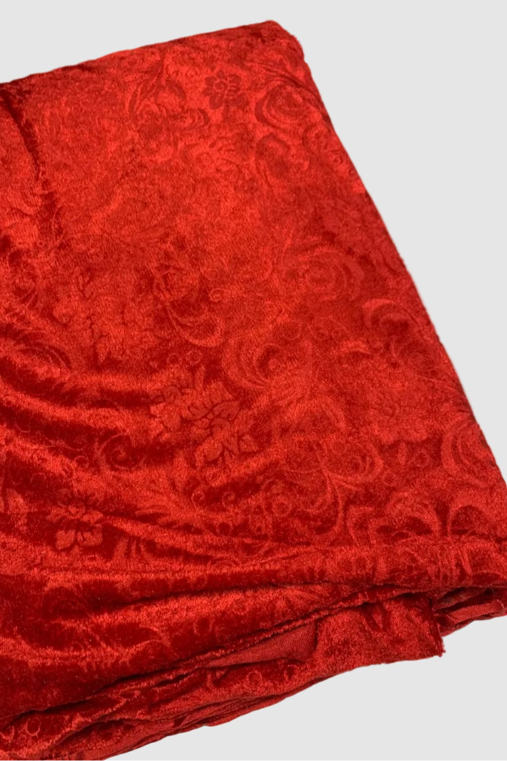 Red patterned fabric on a white background
