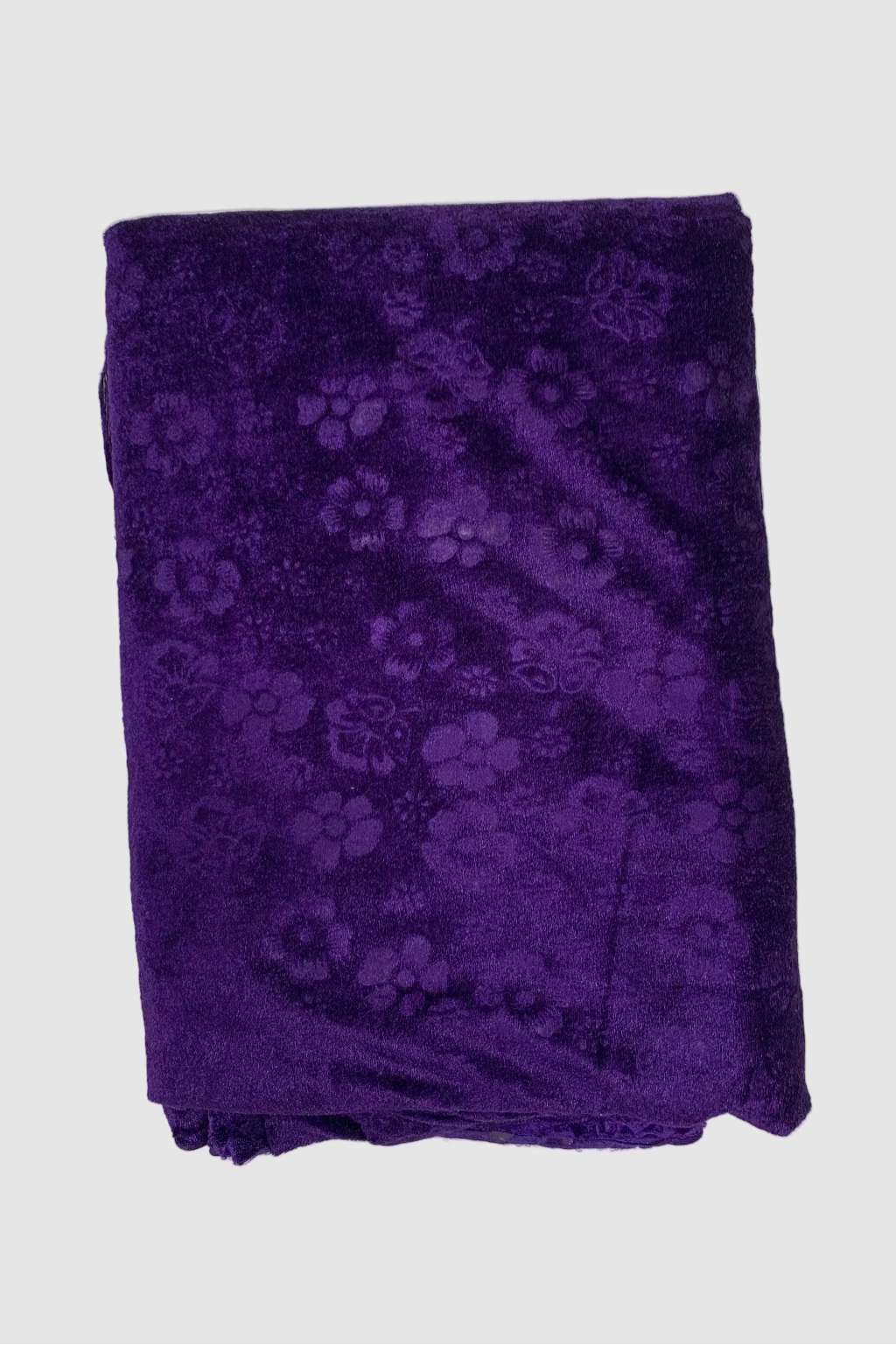 Folded purple fabric with floral pattern on a white background
