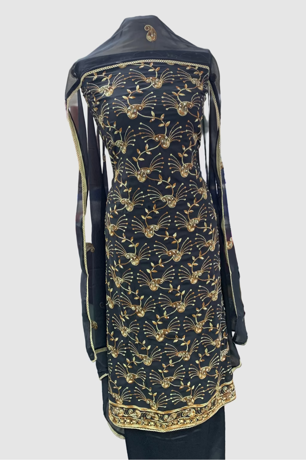 Navy Blue garment with gold patterns on a mannequin in a store setting