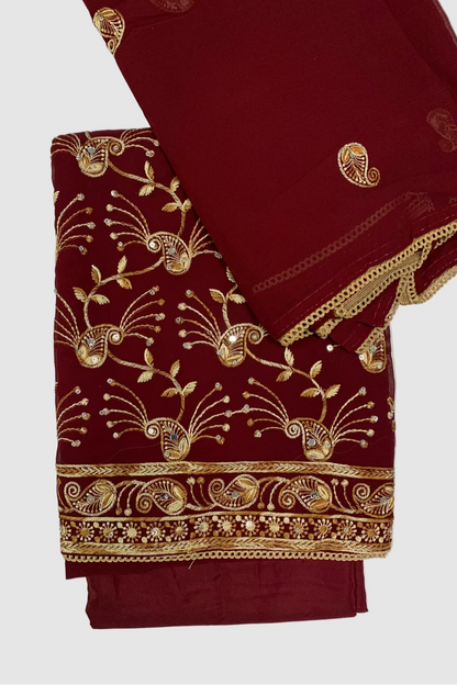 Maroon fabric with gold embroidery on a white background