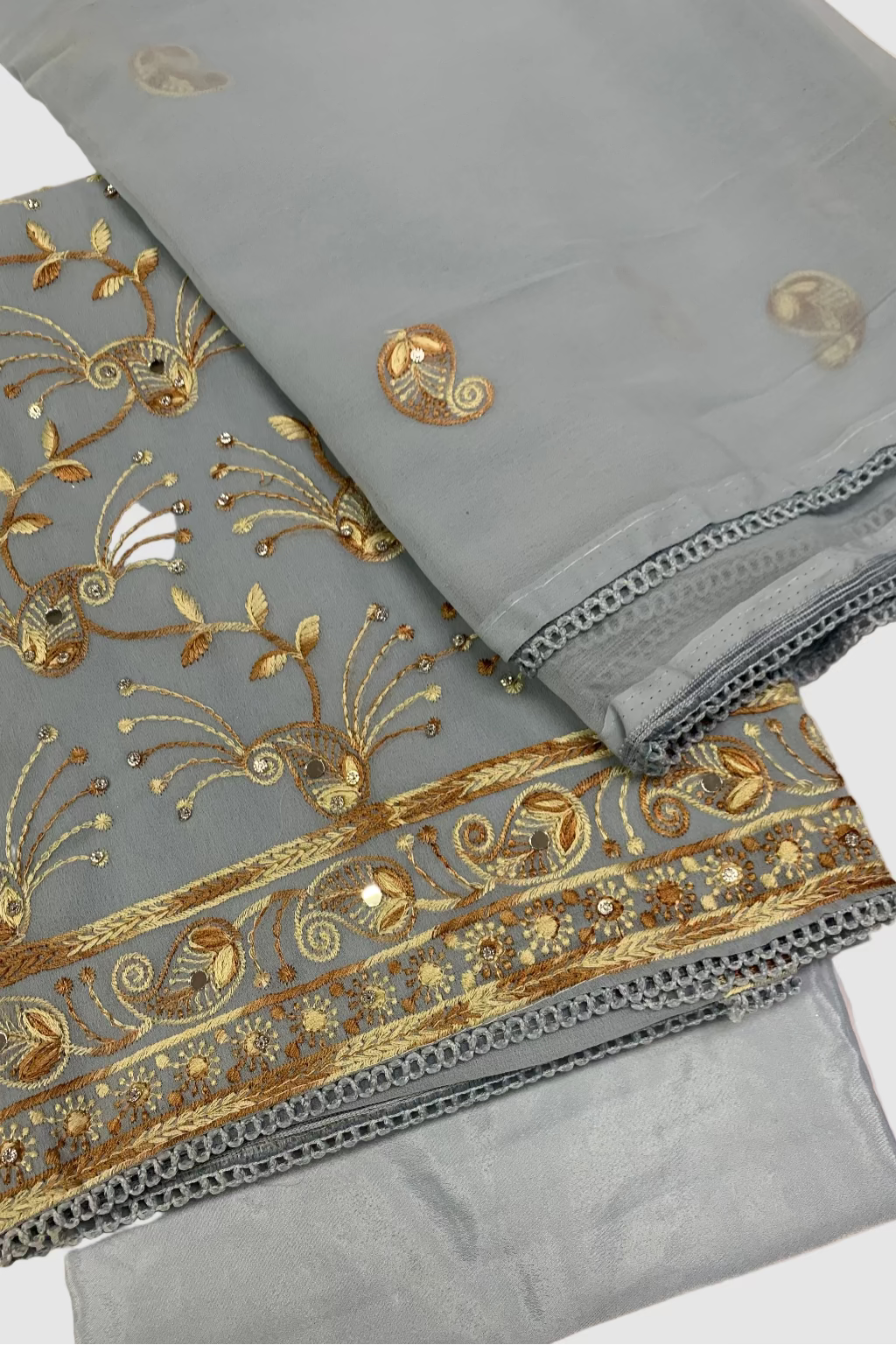 Light blue fabric with gold embroidery on a light background