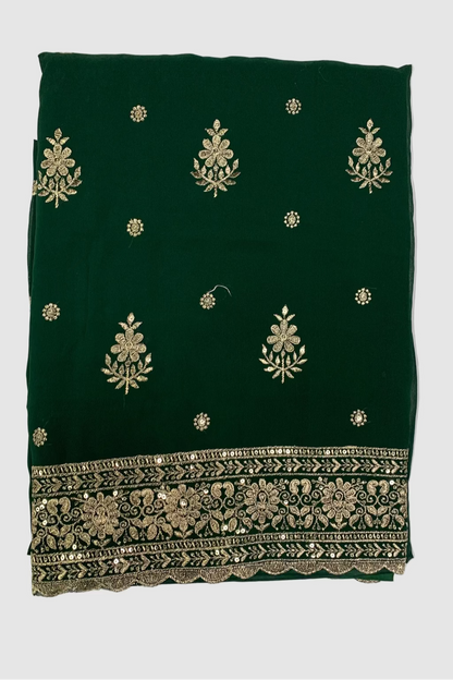 Green fabric with gold embroidery on a white background