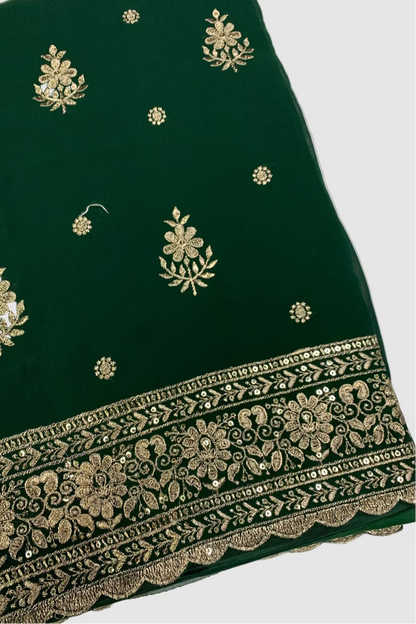 Green fabric with gold embroidery on a white background