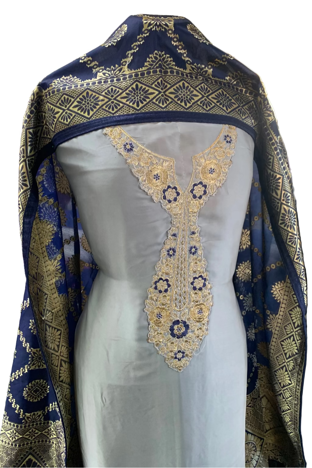 Mannequin wearing a grey dress with gold embroidery and a matching blue and gold headscarf.