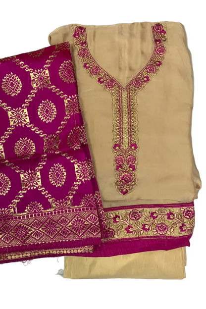 Beige fabric with purple and gold embroidery on a white background