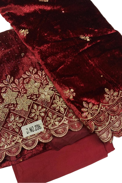 Maroon fabric with gold embroidery on a white background