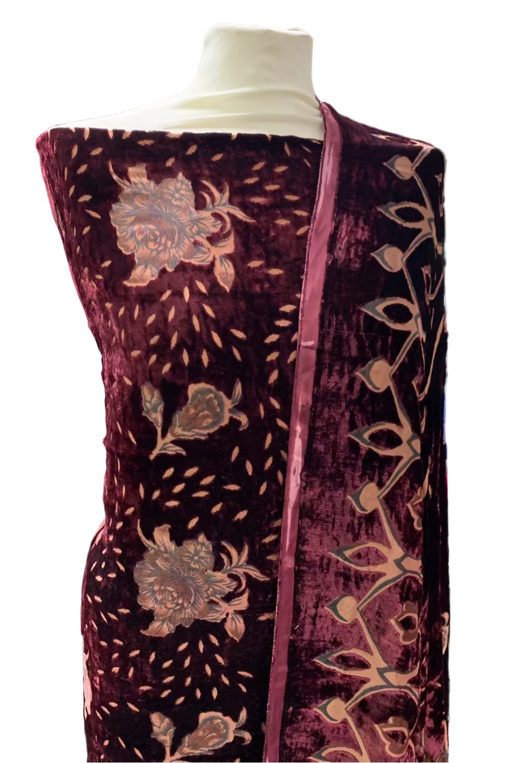 Decorative fabric with floral patterns on a mannequin in a store setting.