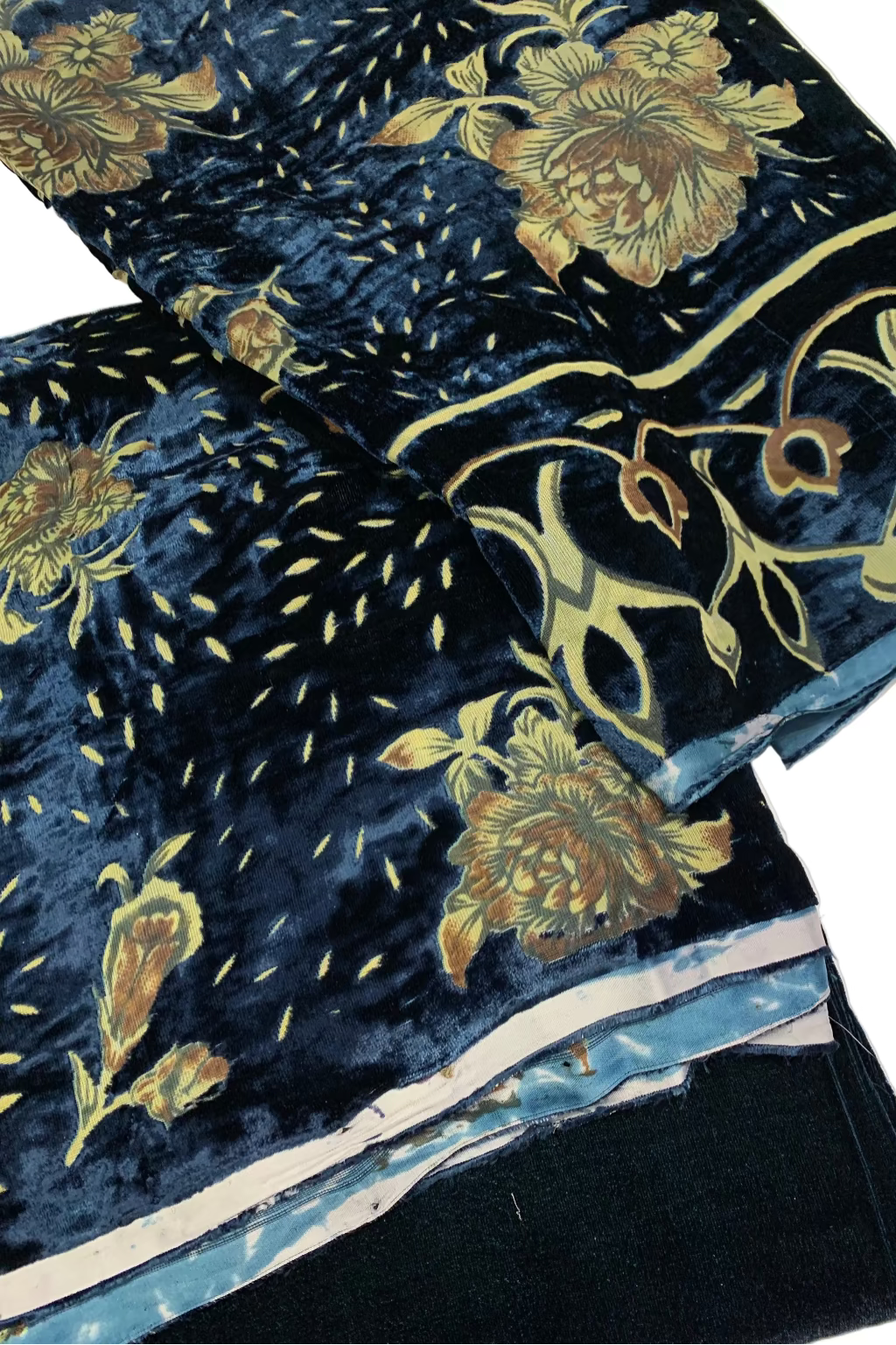 Turquoise velvet fabric with gold floral patterns on a white background