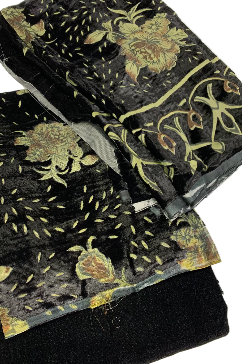 Black velvet fabric with floral patterns on a white background