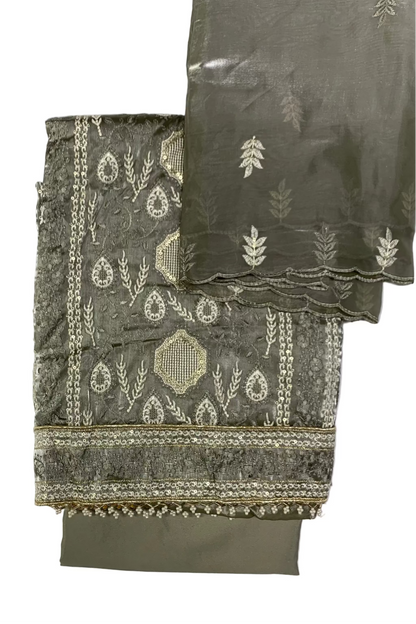 Grey embroidered fabric with white patterns on a light gray background