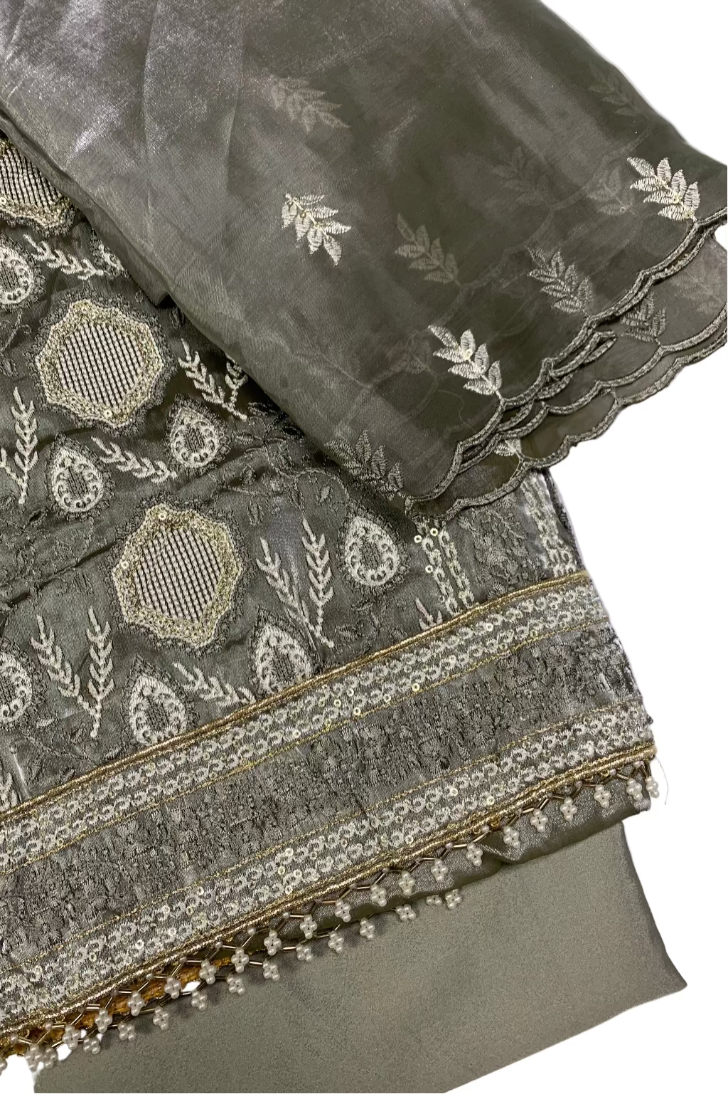 Embroidered fabric with intricate patterns on a white background