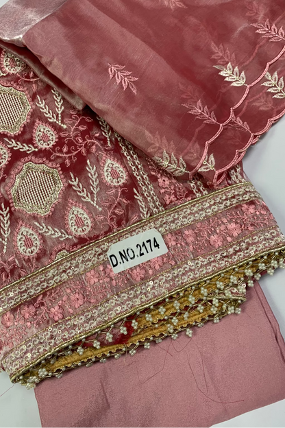 Pink embroidered fabric with a label on a white background