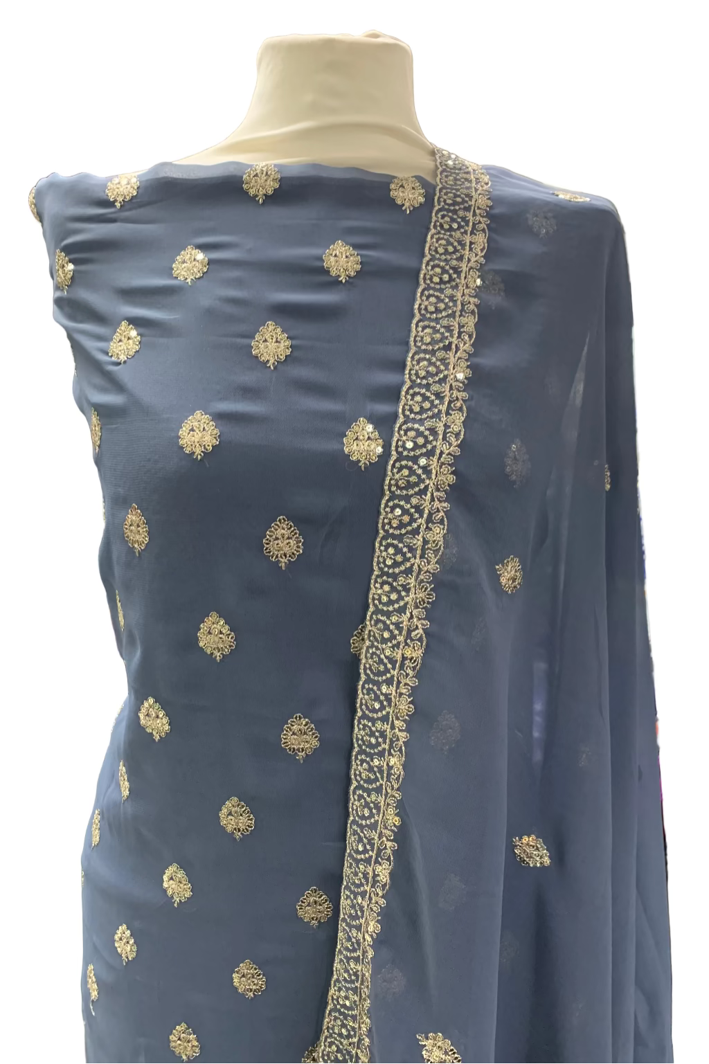 Grey embroidered fabric on a mannequin in a store setting